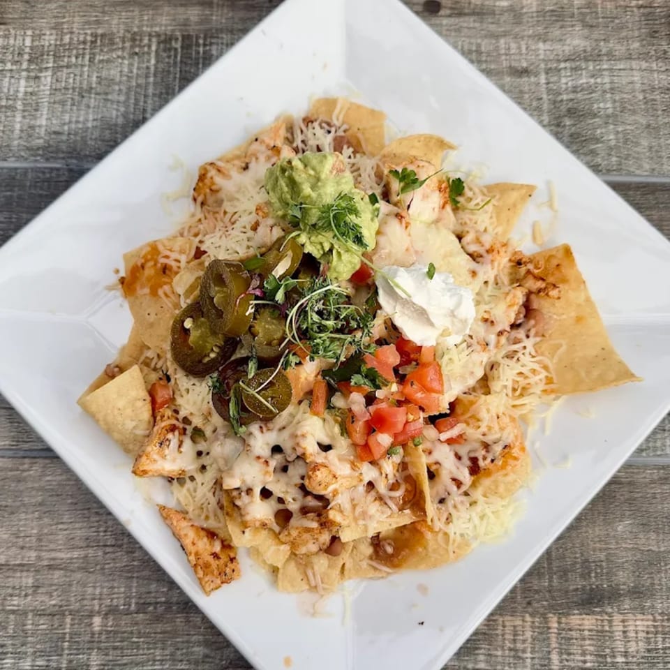 El Patio's chicken nachos with melted cheese, guacamole, sour cream, pico de gallo, and jalapeños.
